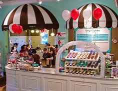 the inside of a candy shop with balloons and decorations