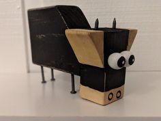 a toy made to look like a black and white dog sitting on top of a table