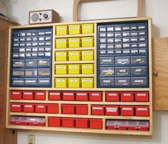 a wooden shelf with many different types of boxes and drawers on it's side