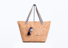 Spice up your daily routine or head to the beach in style with the Ormond Bucket Beach Bag. Made from water-resistant cork fabric, this bag has plenty of space for all your essentials and features a zippered closure, lightweight design, and comfortable straps. Plus, there's an exterior pocket for easy access to your must-haves. It's the perfect combination of fashion and functionality! FEATURES Water Resistant Zipper closureWoven patterned Shoulder Strap11.5" Drop Interior - zippered pocket & op Cork Material, Instagram Beach, Cork Fabric, Linen Set, Natural Baby, Romper With Skirt, Bagpack, Jewelry Bags, Hostess Gifts