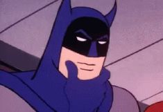 the batman animated character has his hand up to his face and is wearing a blue cape