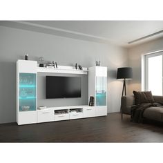 a living room with a couch, television and entertainment center in white painted wood flooring