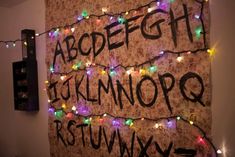 a wall covered in lights with the words abcdefgith written on it