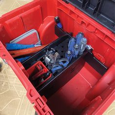 a red toolbox filled with tools and wrenches