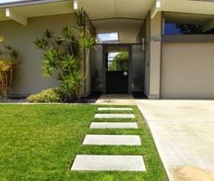 a house with grass and steps leading to the front door