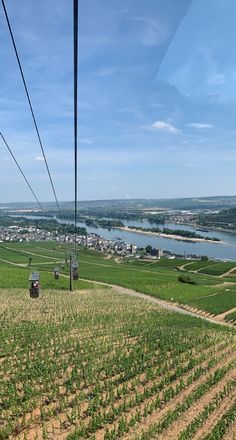 a view from the top of a hill looking down at a field with crops on it