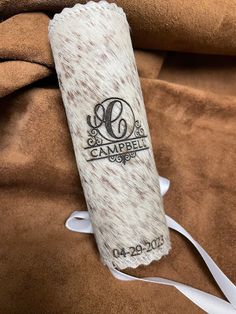 a brown and white blanket with the name camppel on it's back end