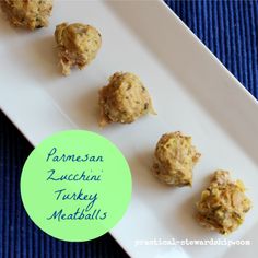 four balls of food on a white plate with a green label that says falmesan zucchini turkey meatballs