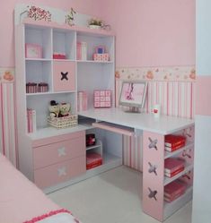 a child's bedroom with pink furniture and accessories on the desk, along with a bed