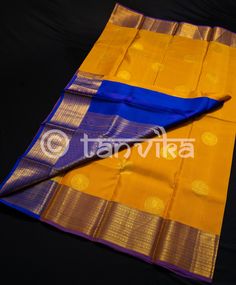 This pure Kanjivaram Pattu silk Saree, glowing in the hue of sunshine, is adorned with intricately elaborate chakra motifs in gold tone zari, illuminates a regal aura. The contrast royal blue border and Pallu featuring zari crafted floral stripes truly elevates the look of this gorgeous saree. These south silk sarees are magic when draped. If you are a die-hard fan of Indian ethnic wear, then these sarees are perfect to have in your wardrobe. They can be worn for bridal, wedding, traditional, re Gold Paithani Silk Dupatta With Tilla Details, Gold Paithani Silk Dupatta With Tilla, Gold Chanderi Saree With Tilla Details, Yellow Tilla Saree For Puja, Yellow Saree With Tilla For Puja, Yellow Tilla Saree For Diwali, Bridal South Indian, Pattu Silk Saree, Gorgeous Saree