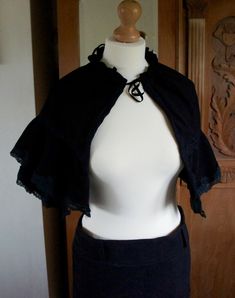 Handmade Victorian Style Black Moleskin Ladies Cropped Cape With Layered Lace Edged Detail.  The size is adjustable as the cape gathers at the neckline. This would look wonderful with a victorian gown or as an accessory with a steampunk costume. Please take a look at more wonderful original costumes and accessories available in my shop. I am regularly creating new individual items.  If you would like a custom costume please message me.  Remember to like my shop or follow me to stay updated. Than Fitted Gothic Cape For Costume, Chic Black Capelet, Black Capelet For Evening Wear, Black Capelet For Costume, Black Fitted Capelet, Fitted Black Capelet, Elegant Black Fitted Cape, Victorian Cape, Victorian Gown