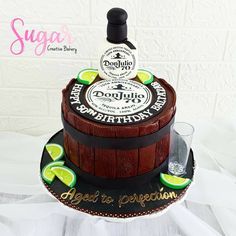 a birthday cake made to look like a barrel with limes on top and tequila