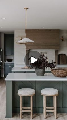 a kitchen with two stools in front of an island