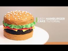 a hamburger cake sitting on top of a white plate