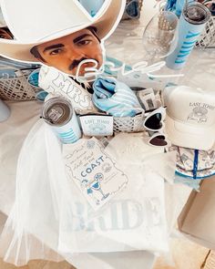 a table topped with paper cutouts and hats on top of eachother's head