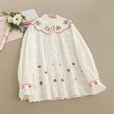 Material: COTTON, Polyester Size Shoulder (cm) Shoulder (in) Bust (cm) Bust (in) Sleeve (cm) Sleeve (in) Length (cm) Length (in) One Size 40 15.7 106 41.7 57 22.4 68 26.8 Spring Cream Blouse With Doll Collar, Cotton Long Sleeve Blouse With Floral Embroidery, White Blouse With Collar For Spring, Embroidered Collar Top For Fall, Embroidered Fall Tops With Collar, Cute Long Sleeve Cream Blouse, Cute Long Sleeve Beige Blouse, Fall Collared Tops With Floral Embroidery, Casual White Blouse With Doll Collar