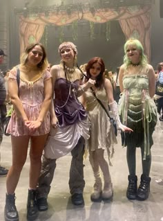 four women dressed in costumes posing for a photo