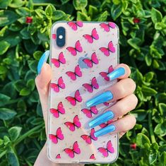 a woman's hand holding up a phone case with pink and blue butterflies on it