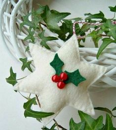 an ornament made out of felt with holly leaves and berries on the top