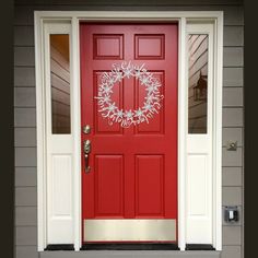 a red front door with a wreath on it