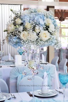 the centerpieces are decorated with blue and white flowers