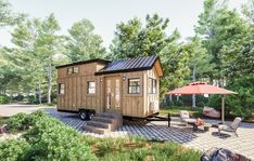 a tiny house with a patio and umbrella