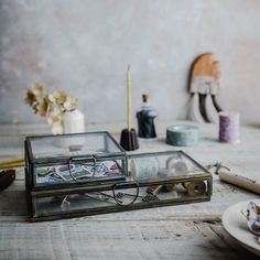 a table with some crafting supplies on it and a pair of eyeglasses