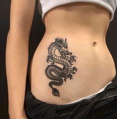 a woman with a dragon tattoo on her stomach