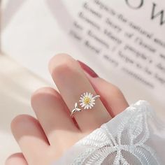 This stunning Adjustable Open Daisy Ring features a beautiful blend of 925 silver and 18K gold. Its minimalist design and adjustable size make it a perfect gift for her, adding elegance to any outfit. Quality Materials - Crafted from 925 sterling silver and accented with 18K gold, ensuring durability and a luxurious finish. Adjustable Size - Designed to fit comfortably on any finger, making it perfect for gifting without worrying about sizes. Minimalist Design - The open daisy design adds a subt Silver Cuff Ring, Romantic Rings, Daisy Jewelry, Sunflower Ring, Daisy Studs, Daisy Ring, Rings For Girls, Silver Spring, Girls Jewelry