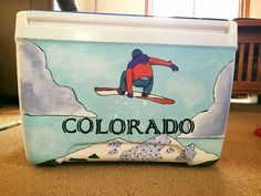 a cooler with a skier on it sitting on the floor