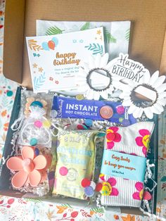 an open birthday box filled with lots of items