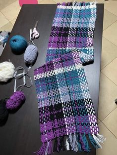 a table topped with yarn and crochet items