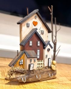 a small wooden house sitting on top of a table