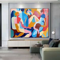 a living room with a large painting on the wall