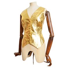 Vibrant 1990's Vintage Gold leather waistcoat by VALENTINO's 'Oliver' Label affectionally named after his favourite Pug. The Garment is crafted from a shiny Gold lamé leather with buttons down the front and a simple black reverse and interior lining. MADE IN ITALY. Measurements provided in Inches; Pit to Pit; 19’’ Waist; 32’’ Nape to Hem; 23’’ Recomended Size; UK 12 for a fitted silhouette / Or will fit smaller sizes if you desire a more oversized look. Condition; 7/10 - there are various minor Leather Waistcoat, Moschino Cheap And Chic, Gold Lame, Boucle Jacket, Evening Jackets, Gianni Versace, Fitted Silhouette, Look Plus, Jacket Buttons