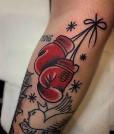 a man with a tattoo on his arm has a red boxing glove and an eagle