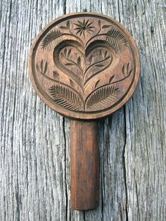 a wooden spoon with an intricate design on it