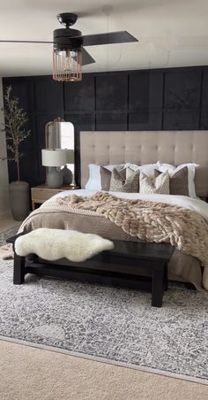 a bedroom with a large bed and rugs on the floor