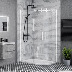 a bathroom with a black and white tile floor, shower head, sink and toilet