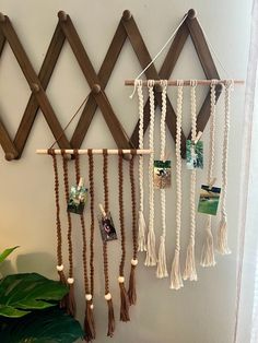 a wall hanging made out of wood and macrame beads with pictures on them