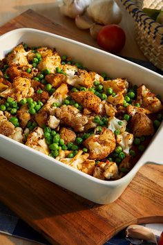 a casserole dish with peas and cauliflower