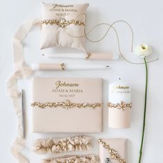 the wedding stationery is laid out on top of each other, along with a flower