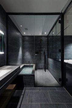 a bathroom with two sinks and a large mirror on the wall next to the bathtub