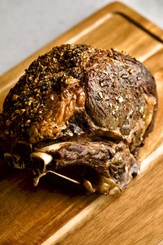 a large piece of meat sitting on top of a wooden cutting board