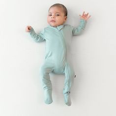 For a cozy night’s sleep that will have the whole family snoozing like babies, try our zippered footies. These bamboo baby pajamas adhere to all AAP safe sleep guidelines, giving you peace of mind throughout the night. With thoughtful features like double stitching for extra security and fold-over cuffs for those newborns that tend to scratch, Kyte Baby has spared no detail. These buttery soft baby sleepers are made of high-quality rayon fabric spun with bamboo fibers, helping to alleviate signs Kyte Baby, Baby Layette, One Piece Clothing, Baby Sleepers, Bamboo Clothing, Sage Color, Baby Pajamas, Cozy Night, One Piece Pajamas