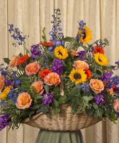 a basket filled with lots of colorful flowers