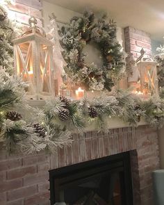 a fireplace decorated for christmas with pine cones and candles