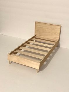 a bed frame made out of wood with no headboard or foot board on it