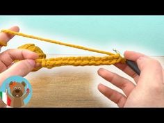 someone crocheting the end of a yellow rope