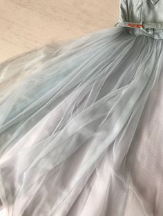 "Hands down one of the sweetest and coolest party dresses ever! That ice blue is just ❄️❄️❄️ And let's talk about that neckline! A X-front which ends in a nipped in waist. The metallic speckled material makes it that much more special. Full full full circle skirt done in silk, tulle and organza. Sooooooooooooo perfect! Condition: Very good. Slight yellow patch on back bodice which is barely noticeable. See second last photo. Fully lined. Bust 31\" Waist 24\" Length 44\" This item is clean and re Light Blue Tulle Party Dress, Fitted Skirt For Summer Prom, Blue Tulle Dress For Summer, Summer Evening Tulle Skirt, Spring Bridesmaid Dress In Light Blue, Light Blue Bridesmaid Dress For Spring, Spring Light Blue Bridesmaid Dress, Fitted Light Blue Tulle Dress, Blue Tulle Skirt For Summer